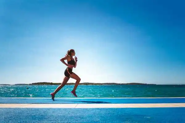 Woman running showing strong leg muscle Brockenhurst